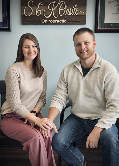 Drs. Kristen Lindsey Sikes and Shane Sikes posing for a photo at the front of the clinic